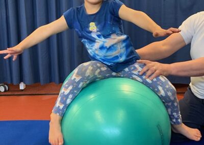 Having fun during advanced balance practice in Physio for child with dyspraxia, developmental co-ordination disorder